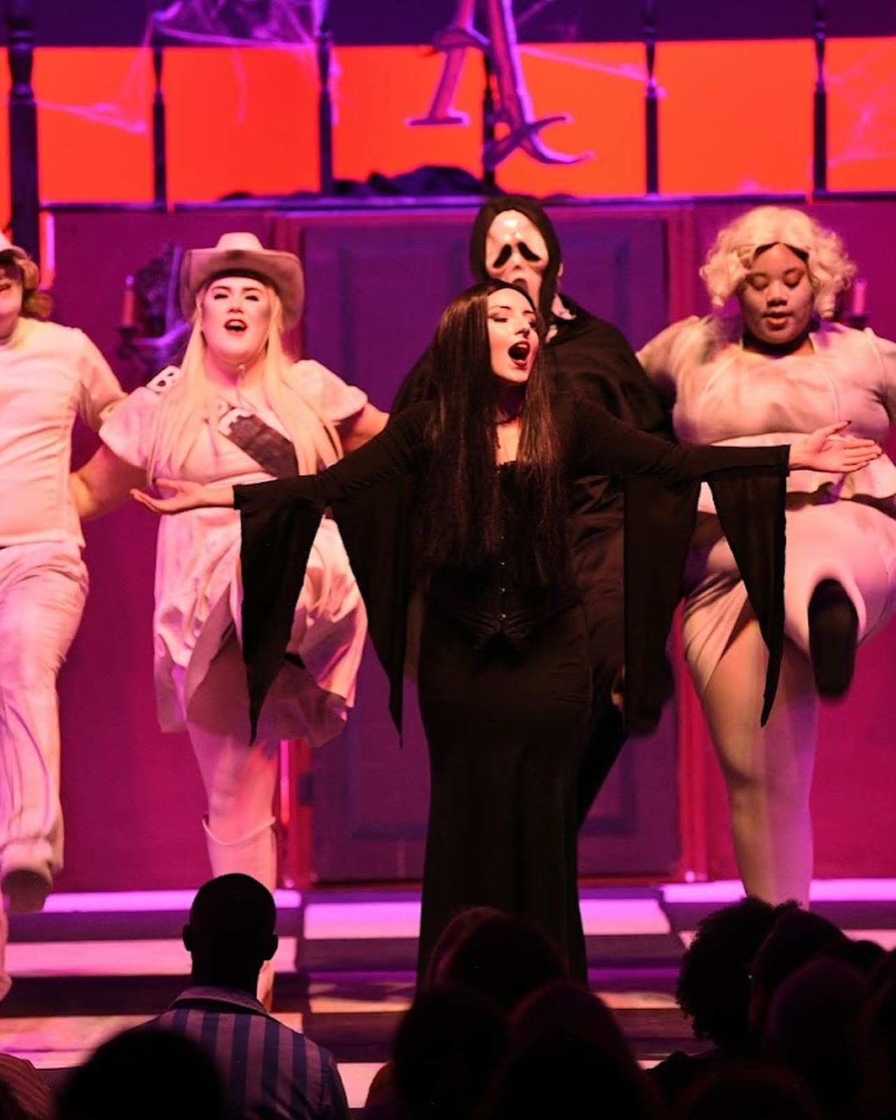 The Addams Family cast performing a musical number on stage